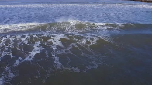 Aerial of ocean surface waves at ocean in the day background