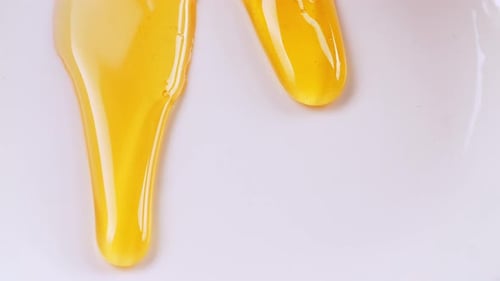 Fresh Honey Drips To The White Background. Organic Thick Honey, Sweet Dessert
