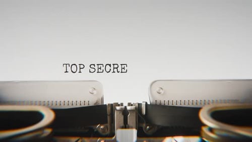 Old mechanical typewriter typing Top Secret Filetop Secret File in a close-up view.