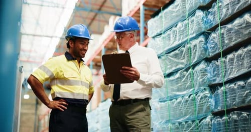 Warehouse, logistics and men with clipboard, talking and planning stock distribution and discussion