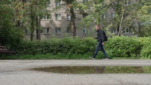 Walker Avoids Puddle Woman or Man Carefully Steps Past Small Pool on Path Pedestrian Carefully