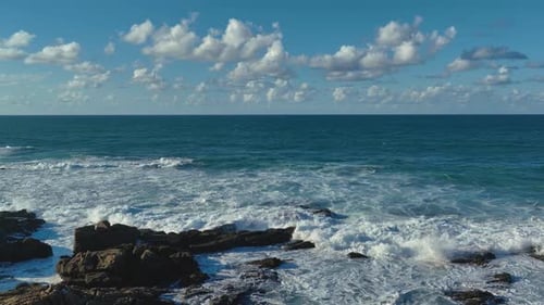 Scenic Sea Waves Breaking Onto Rocky Foreshore During Summer. Aerial Wide Shot