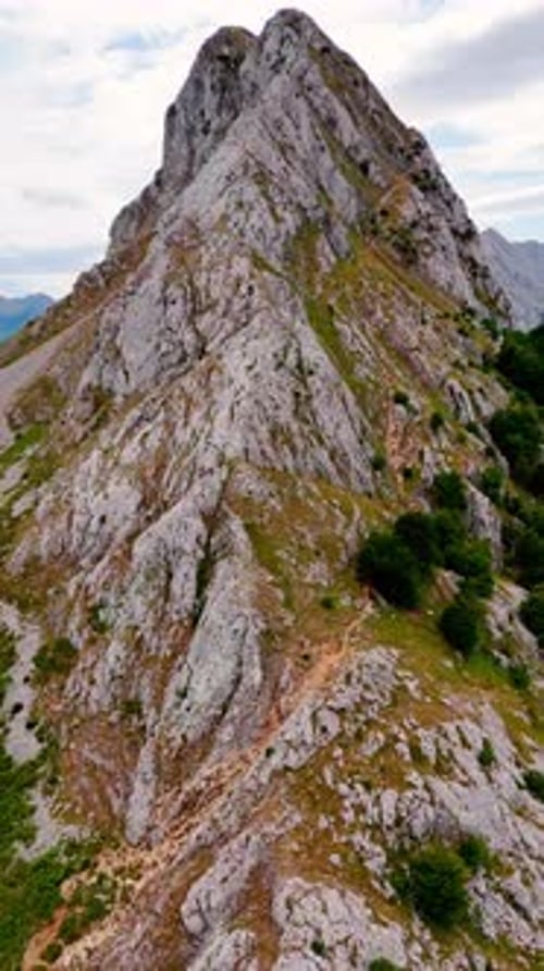 Flight over the mountain ridge rising to the top. Steep rock dangerous to climb. Leon, Spain, Europe