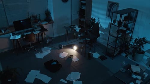 High Angle of Messy Office with Business Papers Scattered on Floor after Robbery