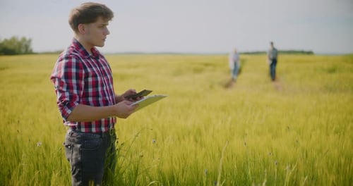 Farmers Standing Agriculture Field Talking Examining Crops Before Harvesting