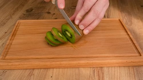 Slicing a kiwi fruit with a knife