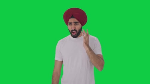 Sick Sikh Indian man suffering from tooth pain Green screen