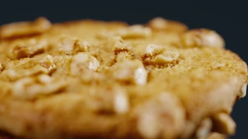 Close Up on Black and Blue Background Flat Plate with Cookie Cookies Built in a Pyramid Sweet