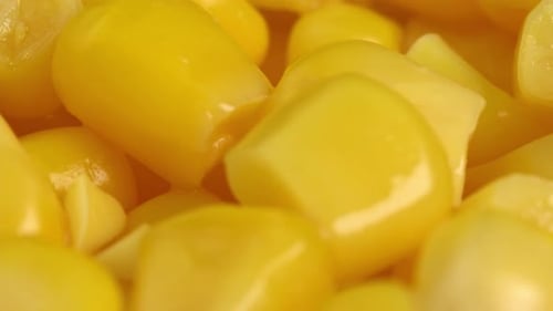 Canned Corn Kernels Gleam in Macro Close Up