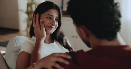 Romantic Couple Talking and Kissing on Couch at Home