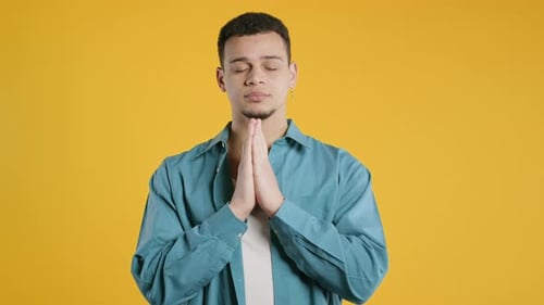 African American 30s Man Praying Begs To Apologize Guilty Yellow Studio Hopeful Prayer