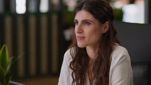 Woman Taking Notes at Desk in Office Workplace