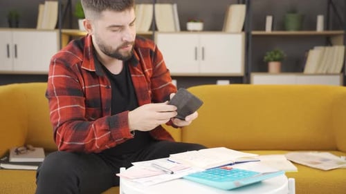 Adult Man Budgeting at Home on Couch