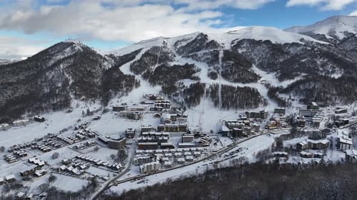 Aerial view of Bakuriani winter resort town with hotels and snow-covered mountains, Georgia 2026