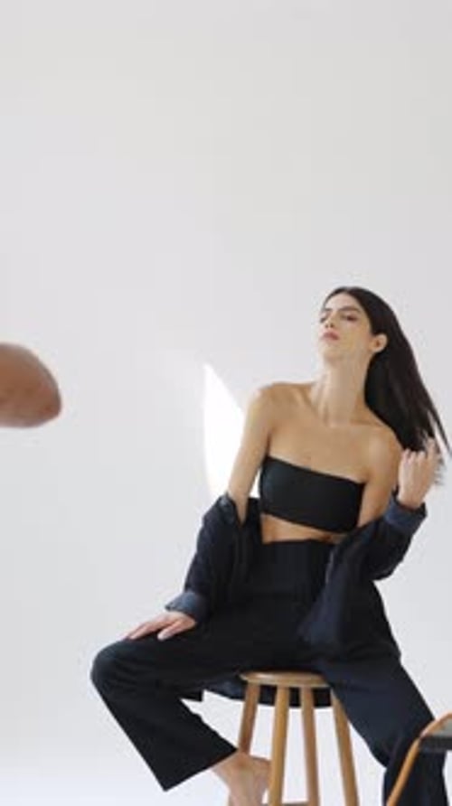 Glamorous Woman in Black Posing in Studio