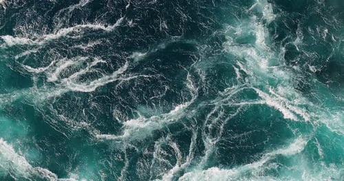 Blue waves of water of the river and the sea meet each other during high tide and low tide.