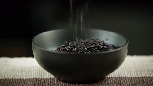 Black Rice Pouring Into Bowl in Slow Motion