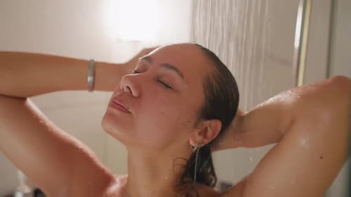 Woman Washing Hair in Shower with Eyes Closed
