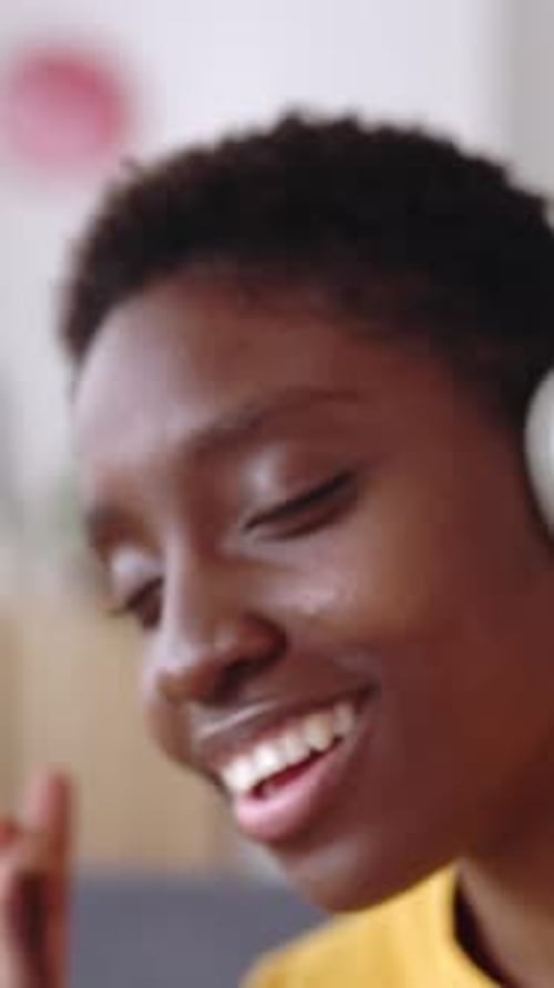 Woman Enjoys Music with Headphones in Home