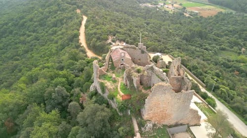 Ruined castle in Europe aerial footage cinematic medieval era Palafolls castle in Barcelona province