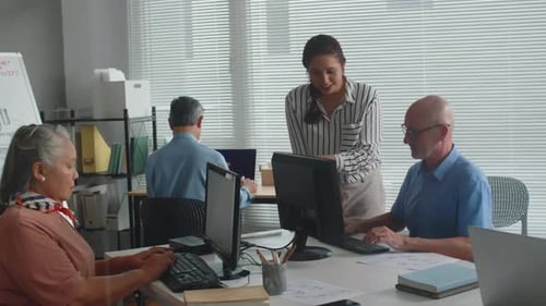 Office Workers Collaborating in Bright Modern Workplace