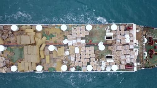 Aerial footage of a Medium size Livestock carrier cruising slowly