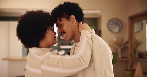 Affectionate Couple Embracing and Kissing at Home