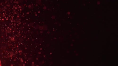 Red light shining on dust particles in the air.