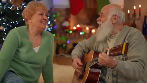 Elderly Couple Celebrates, Man Plays Guitar