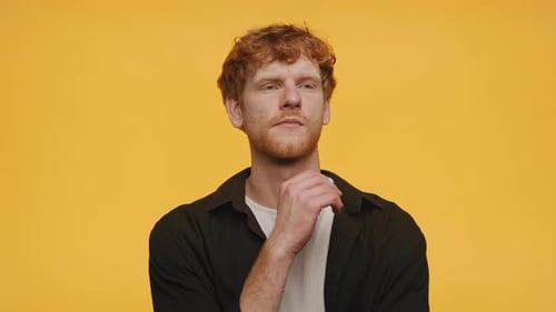 Man Ponders a Thought on Yellow Background