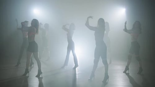 Group of Women Dancing in Smoke-Filled Room