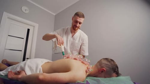 Cupping Treatment on Man's Back for Healthcare