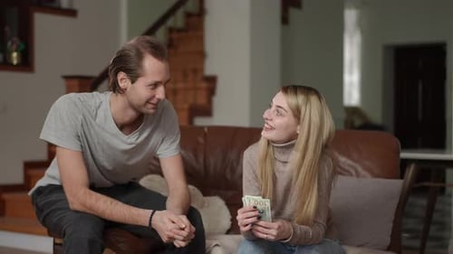 Couple Discussing Money and Finances at Home with Laptop
