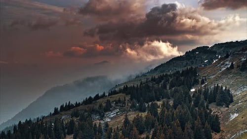 Breathtaking Dusk View of Majestic Mountains and Lush Hills with Beautiful Clouds