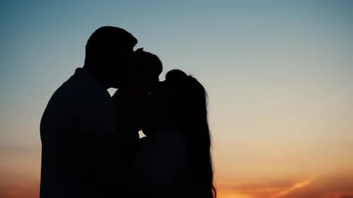 Happy Family at Sunset in the Field Adults Having Fun with Their Children