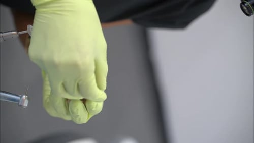 Dentist Manipulates a Dental Model with Gloved Hands