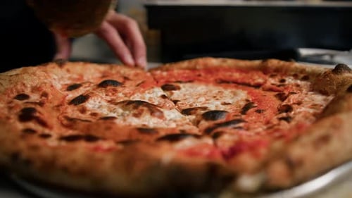 Freshly Cooked Pizza Being Sliced With Cutter