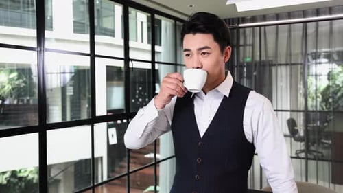 Professional Man Drinking Coffee in Modern Office
