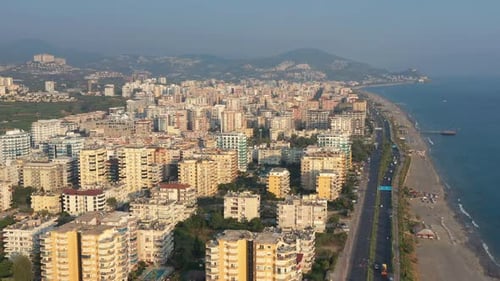 Aerial panoramic view of modern city with beach and traffic at daytime