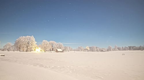 Timelapse shot of white snow covered landscape along rural countryside from evening to night with st