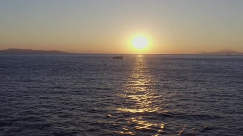 Aerial - Yacht cruising at sunset