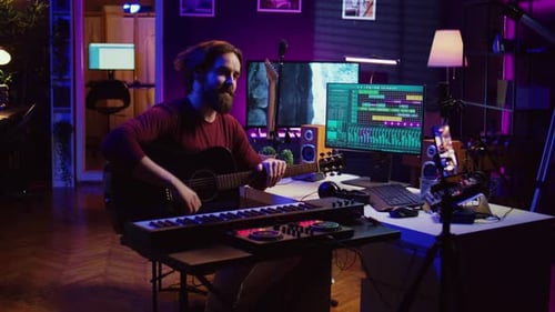 Man Plays Guitar in Colorful Home Recording Studio