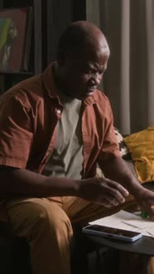 Worried Adult Uses Inhaler Indoors