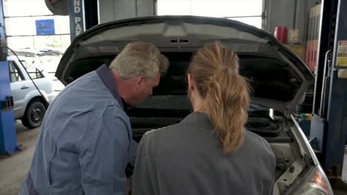 Mechanics Working on Car in Garage 30s
