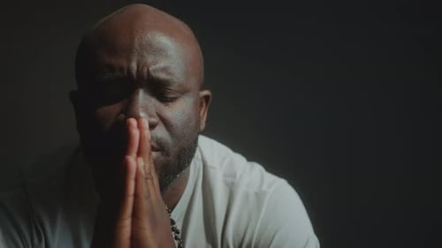 Adult Man Praying with Hands Together