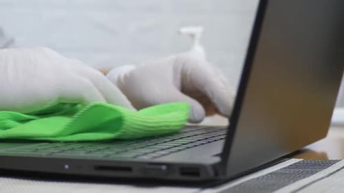 Male Person's Use Wet Green Napkin Cleans Laptop Keyboard