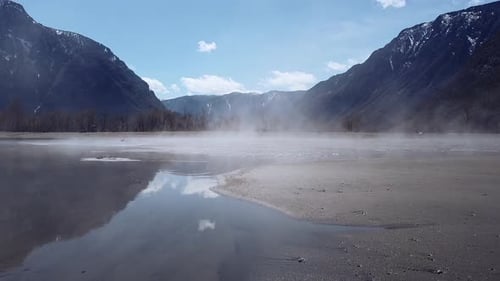 Mystic Mountain Lake with Mist and Blue Sky Offers Tranquil Solitude Breathtaking Sight of Nature