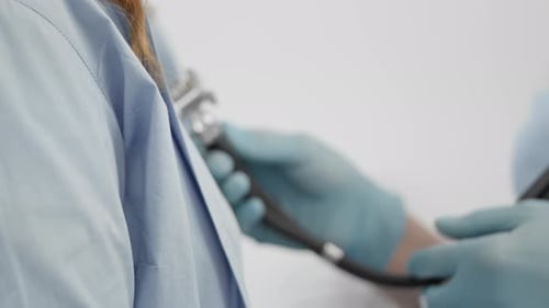 Doctor Using Stethoscope for Medical Exam Close Up