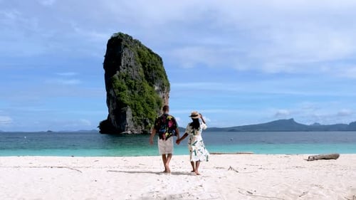 Couple Enjoys a Romantic Stroll on Koh Poda Beach in Krabi Thailand