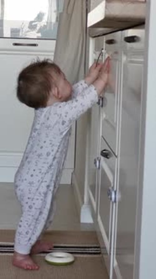 Adorable Infant Reaches for Kitchen Cabinets